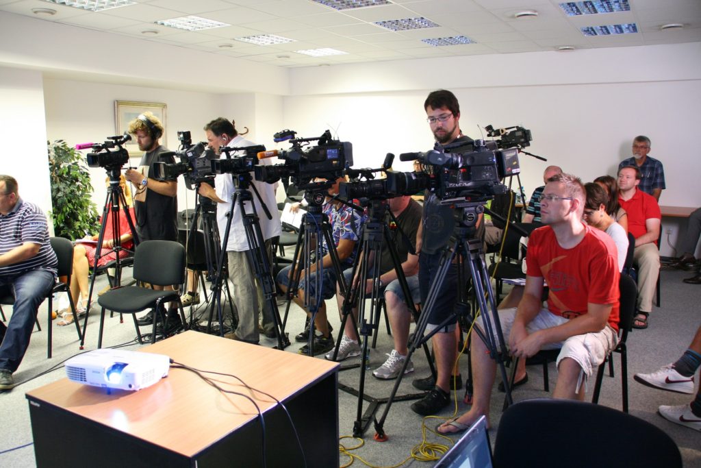 Cameras set up at a press conference