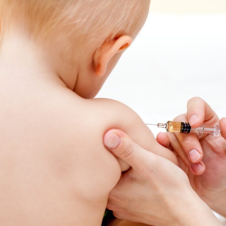 Image of young child receiving an injection